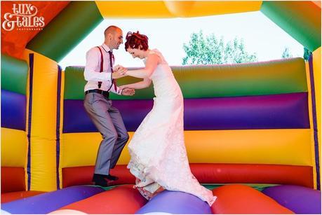 bride & groom bounce in a bouncy castle 