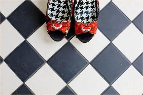 Red and Black tattoo shoes on a chequered floor