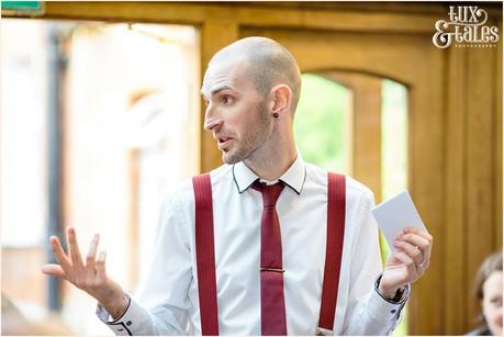 Groom wearing red braces gives speech