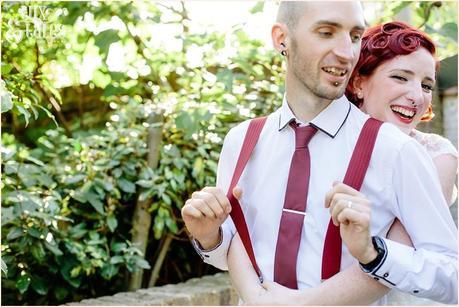 Bride plays with grooms braces at London wedding tattooed couple 