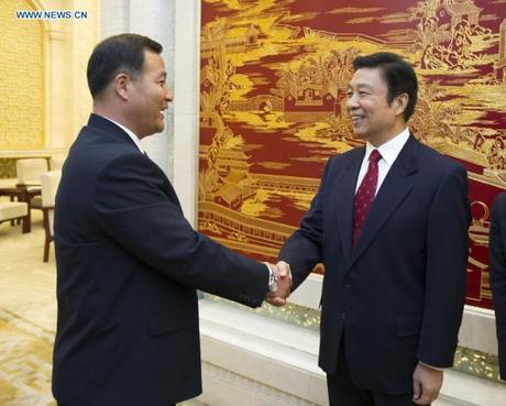 Jon Yong Nam (L), Chairman of the Kim Il Sung Socialist Youth League Central Committee, shakes hands with Chinese Vice President Li Yuanchao (R) at the Great Hall of the People in Beijing on 18 October 2013 (Photo by Xie Huanchi, Xinhua News Agency).