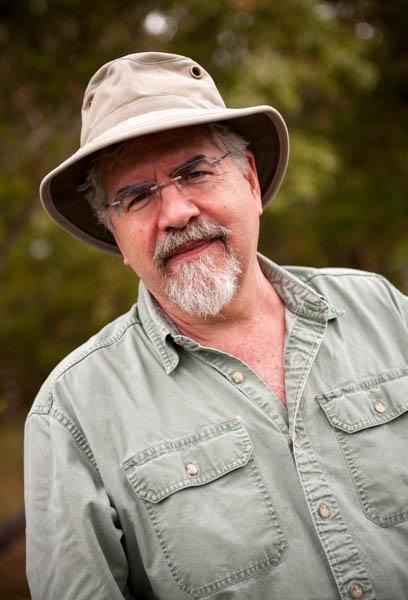 Man in hat with trees in background