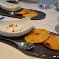 mini make ki rotis and freshly churned white butter topped with grated jaggery