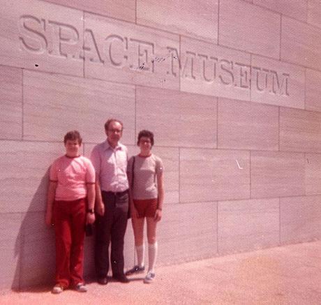 Two children and father in front of the National Air and Space Museum, 1976
