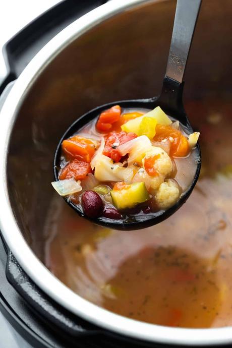 close up view of vegetable soup on ladle