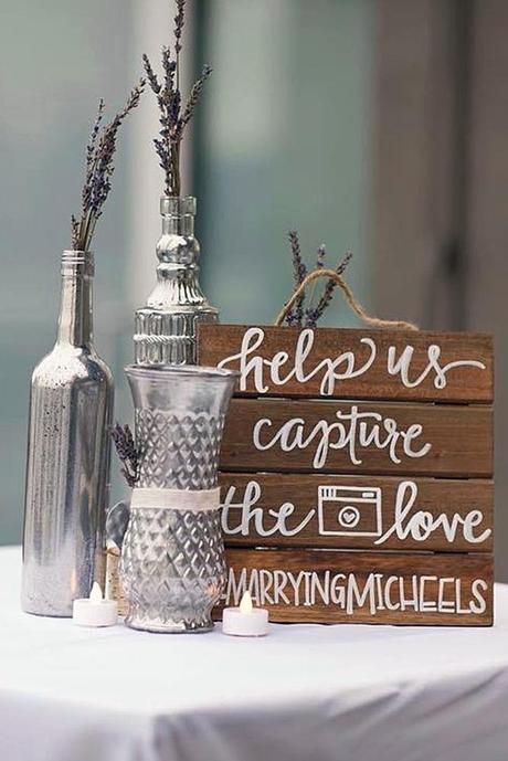 popular wedding signs on board pallets beside the silvery bottles with lavender the ever events