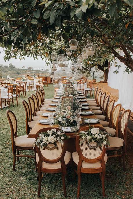 summer wedding trends outdoor table with hanging candles and flower tablerunner studio croma