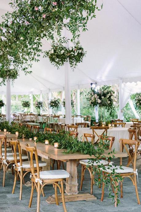 summer wedding trends reception under white tent with tall centerpieces and hanging greenery alisaferris