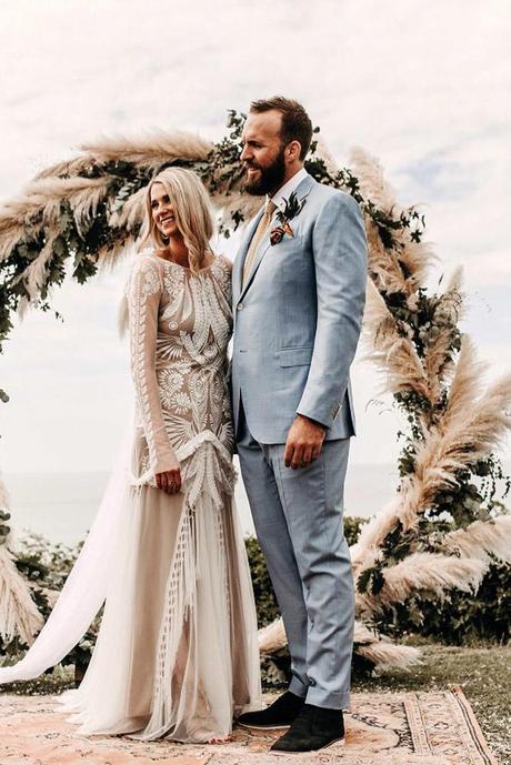 summer wedding trends bohemian bride and groom on the background of a round arch with pampas grass yorisphotographer