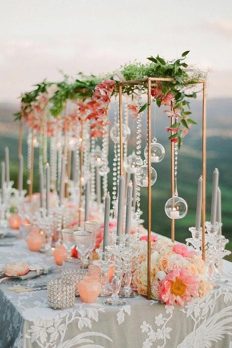 summer wedding trends tall centerpiece with coral orchids and peonies hanging crystals and candles flowers greg finck
