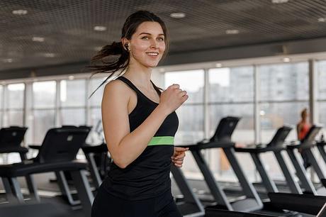 Woman using Redux Buds while working out