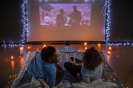 A couple watching a movie with Prima Projector
