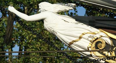 Earlier photograph of a similar figurehead, but her looser shift shows signs of wear and damage.