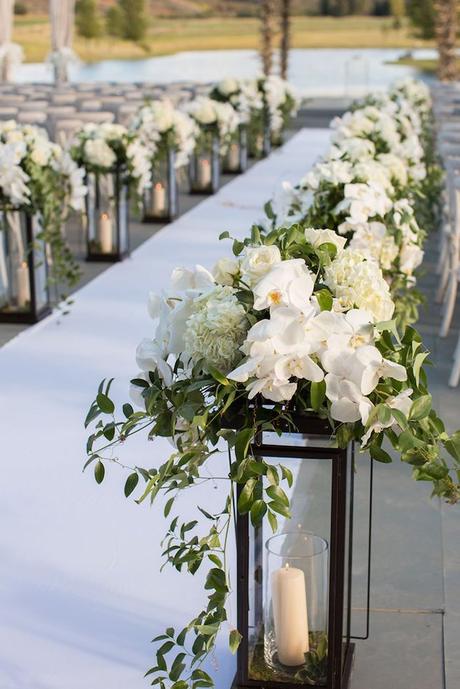 wedding aisle decoration ideas with lantern and flowers brett butterstein photography