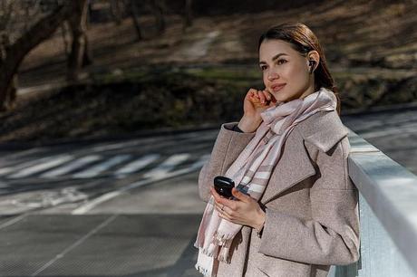 a woman using xfyro headphones outdoors