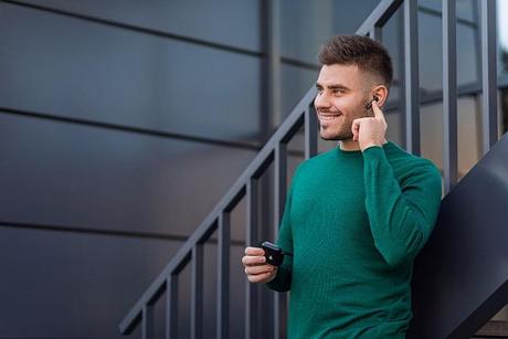 A man using xfyro headphones to take a phone call