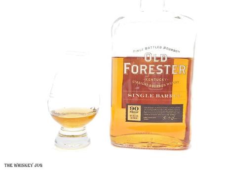 White background tasting shot with the Old Forester Single Barrel bottle and a glass of whiskey next to it.