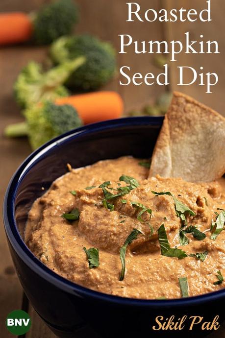 Large vertical Pinterest Photo of a bowl with my Roasted Pumpkin Seed Dip.