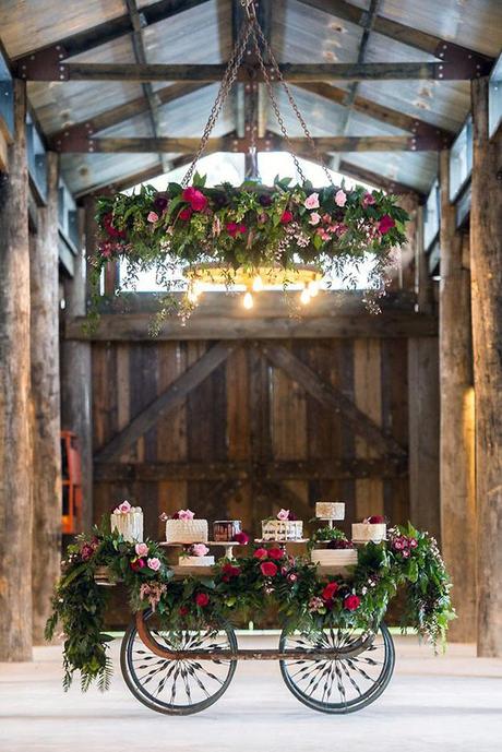 wedding dessert table ideas wooden barn decorated with greens and roses magazine via instagram