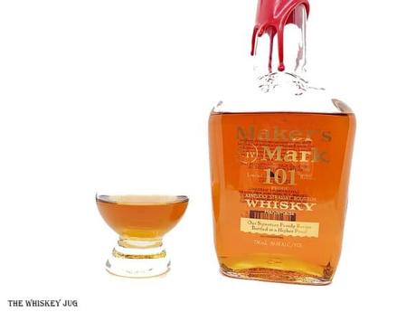 White background tasting shot with the Maker's Mark 101 Proof bottle and a glass of whiskey next to it.