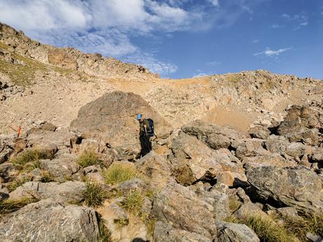 Hiker climbing down a boulder field from Mueller Hut in Aoraki Mt Cook National Park