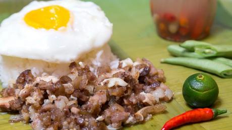 Sisig served with rice and egg