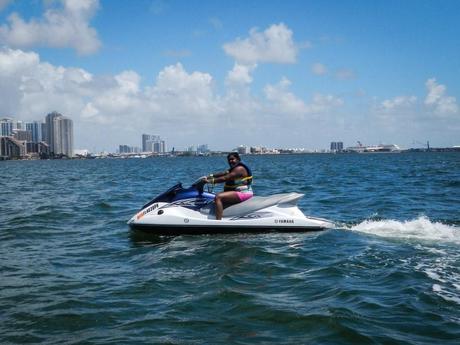Lauren riding a jet Ski as part of her Tropical Sailing Miami tour