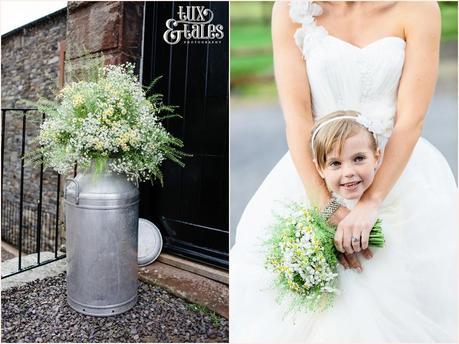 Bride wraps flower girl up in her dress skirt at Lake District Wedding 