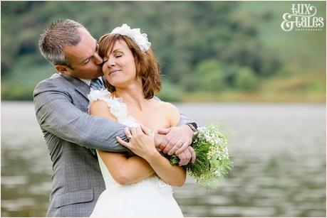 Groom kisses bride at lake buttermere wedding 