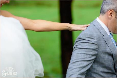 Bride reaches for groom at Lake Buttermere