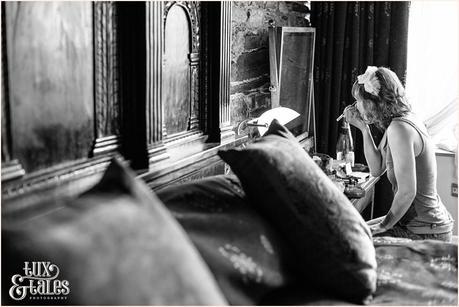 bride puts on makeup in an old farmouse