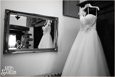 Reflection of bride and wedding dress in the mirror at lake district wedding 