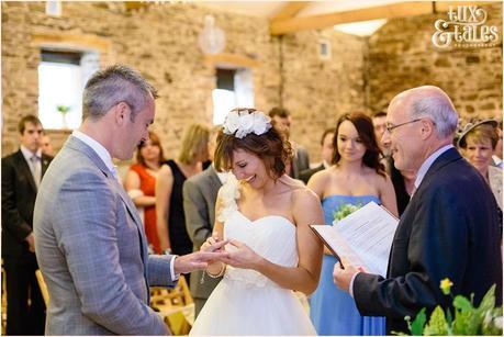 Barn wedding in the Lake District during the exchange of the rings