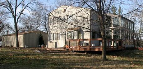 1970s built house with siding and deck