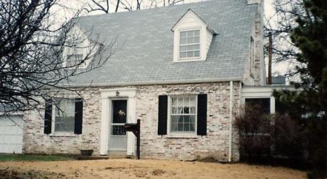 whitewashed brick Cape Code style house