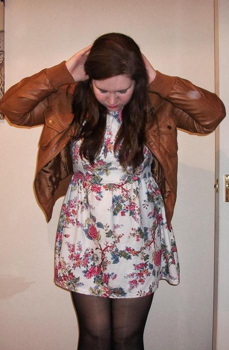 a new look dress which is white with a flower design and a tan leather jacket