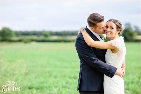 Barmbyfield Barn Wedding photography couple embracing in field