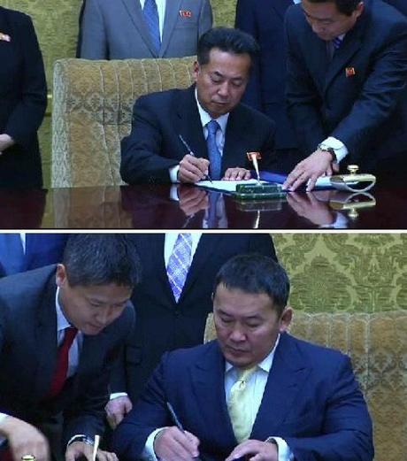 DPRK Minister of Foreign Trade Ri Ryong Nam and Mongolian Minister of Industry and Agriculture Khaltmaa Battulga sign an economic cooperation agreement in Pyongyang on 28 October 2013 (Photos: KCNA screen grabs).