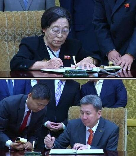 Chair of the Korean Committee for Cultural Relations with Foreign Countries Kim Jong Suk and Mongolian Minister of Foreign Affairs and Trade Luvsanvandan Bold sign an agreement on sports and cultural exchanges and tourism in Pyongyang on 28 October 2013 (Photos: KCNA screen grabs).
