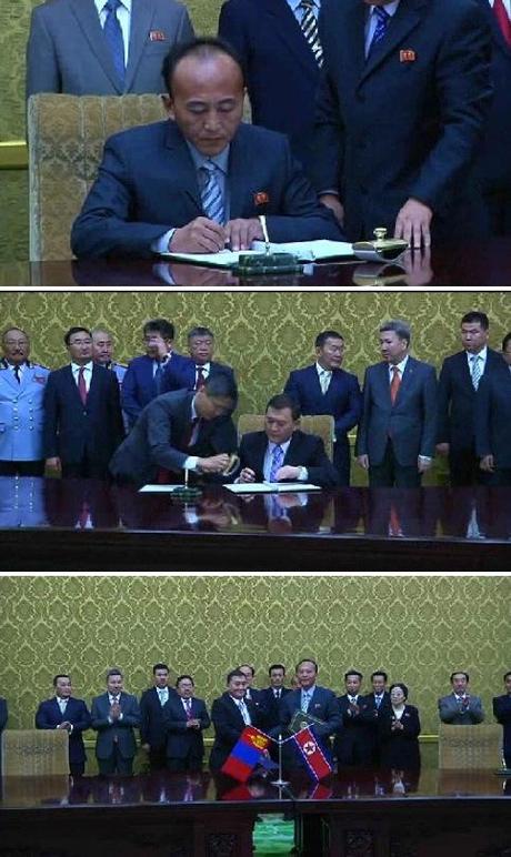 Deputy Director-General of the DPRK General Bureau Software Industry Jong Song Chang and Mongolian Ambassador to the DPRK Manibadrakh Ganbold sign a technology exchange agreement effective from 2013 to 2015 in Pyongyang on 28 October 2013 (Photos: KCNA screen grabs).