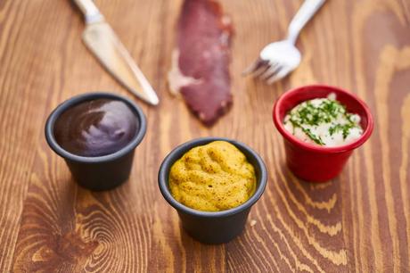 a mustard sauce along with other two sauces