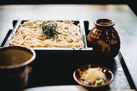 white pasta on black wooden plate with soba noodles