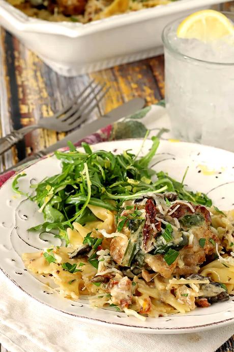 Mushrooms, Sun-Dried Tomatoes, and Spinach are all in this Instant Pot Tuscan Chicken Served on a White Plate