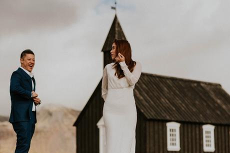 Married couple in front of a black church in Iceland