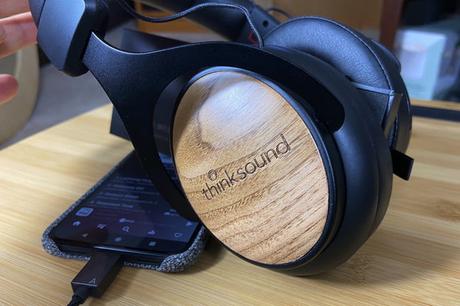 Close-up of Thinksound OV21 wired headphones' walnut cover.