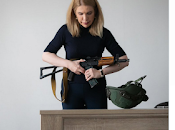 Here's Woman Politician with Assault Rifle Behind!