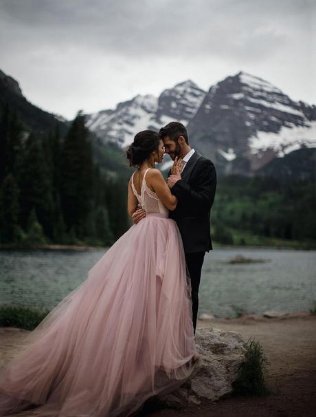 Newly married couple posing for wedding photos at Maroon Bells in Colorado