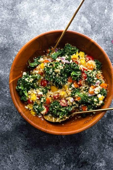 kale quinoa salad in wooden bowl all mixed up