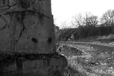 Sparkychan ponders the future of AI while sitting beside a railroad track