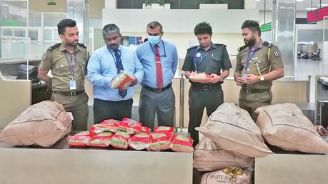 Customs officials at the Bandaranaike International Airport with the consignment of cardamom that they had seized.